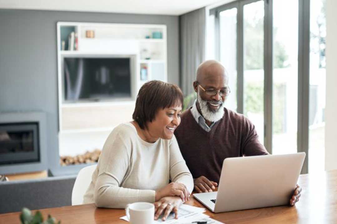 Couple analyzing documents while sitting at home