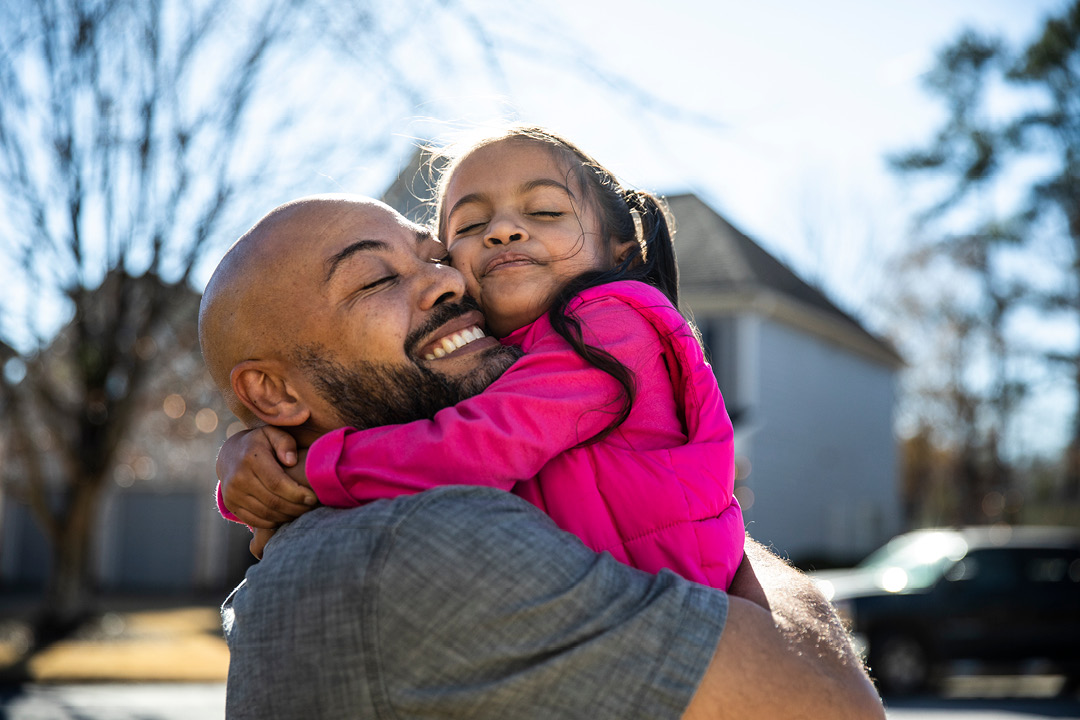 Dad embracing daughter